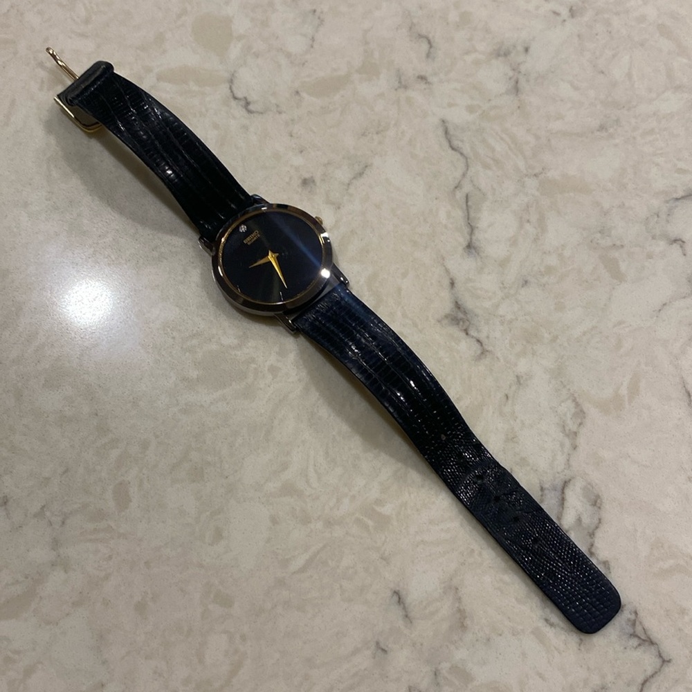 Seiko men’s black leather watch with diamond chip and gold accents